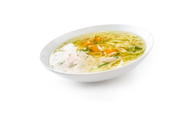 Chocken or beef soup with noodles carrot and parsley herb isolated on white.