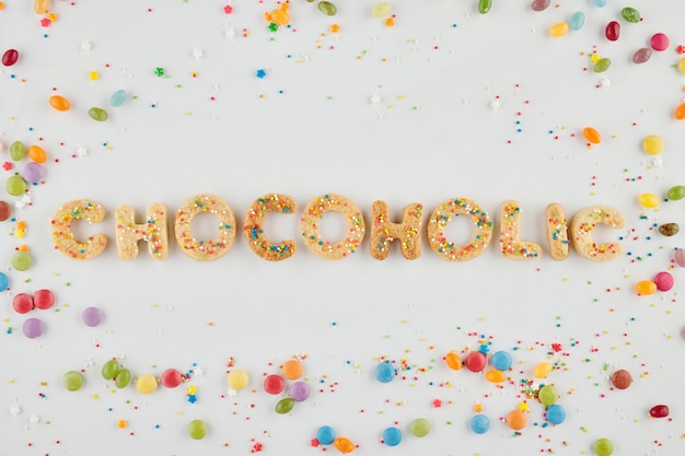 Chocoholic inscription made of vanilla sugar cookies and decorated with colorful sprinkles