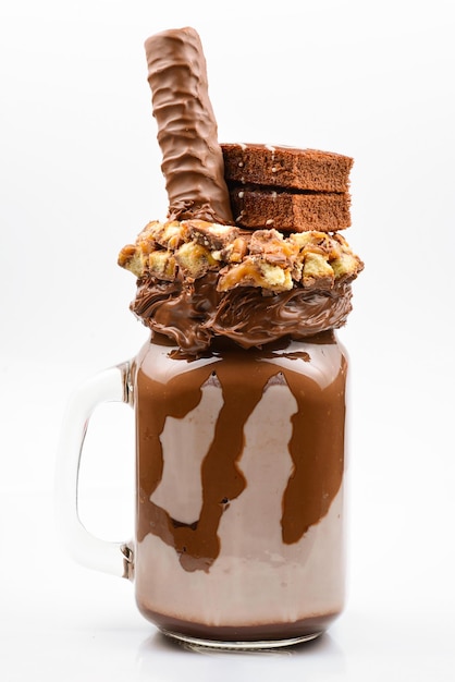 Chocolade extreme milkshake met browniecake, chocoladepasta en zoetigheden. Gekke freakshake-voedseltrend. Ruimte kopiëren