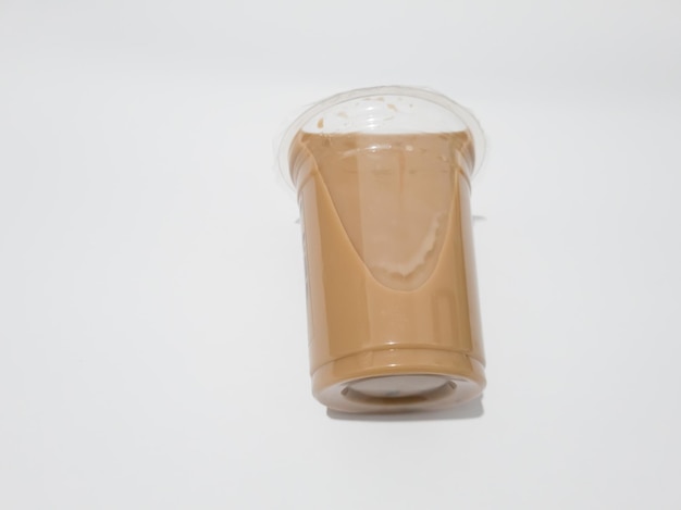 Foto chocoladedrink in plastic bekerverpakking op witte achtergrond