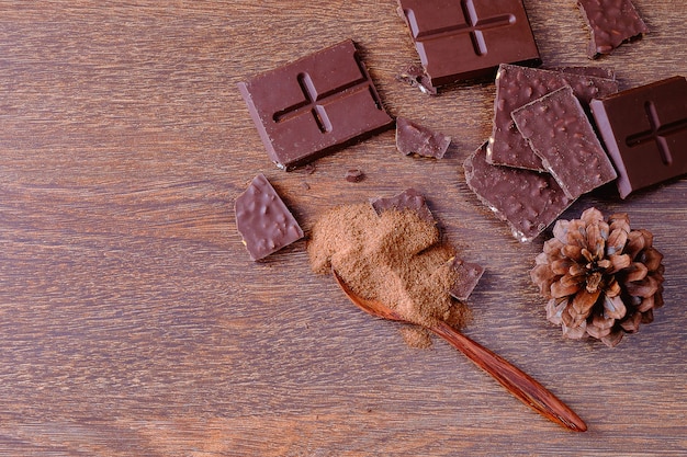 Chocoladerepen en chocoladepoeder op houten planken