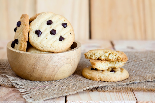 Chocoladeschilferkoekjes op rustieke houten lijst.