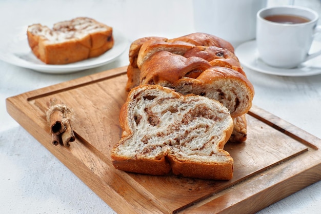 Photo chocolate babka or brioche bread-chocolate swirl bread, sliced on white background.