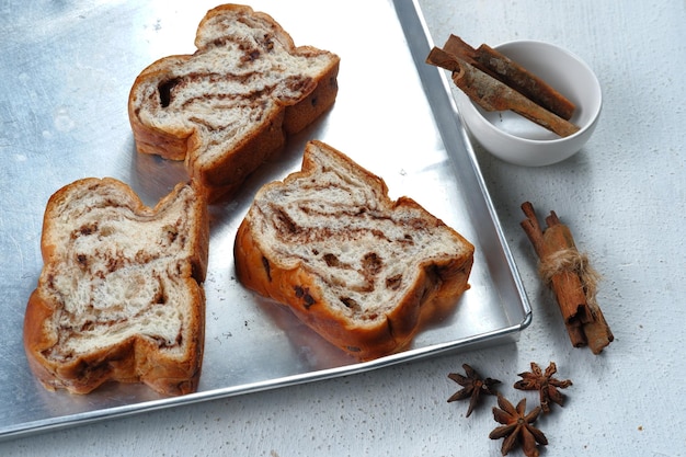 Photo chocolate babka or brioche bread-chocolate swirl bread, sliced on white background.