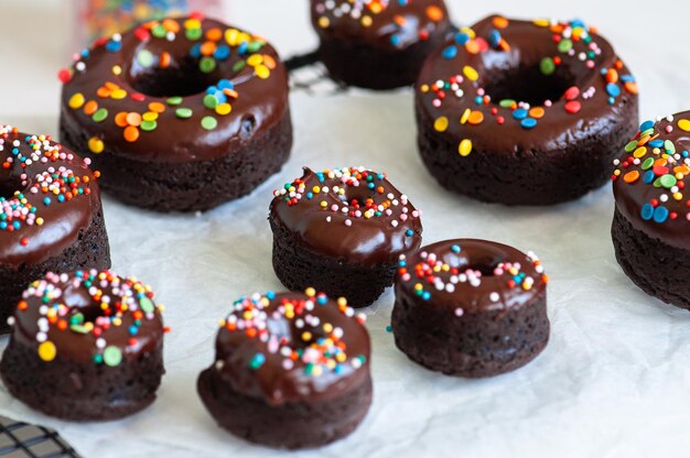 Chocolate baked doughnuts with chocolate frosting and sprinkles