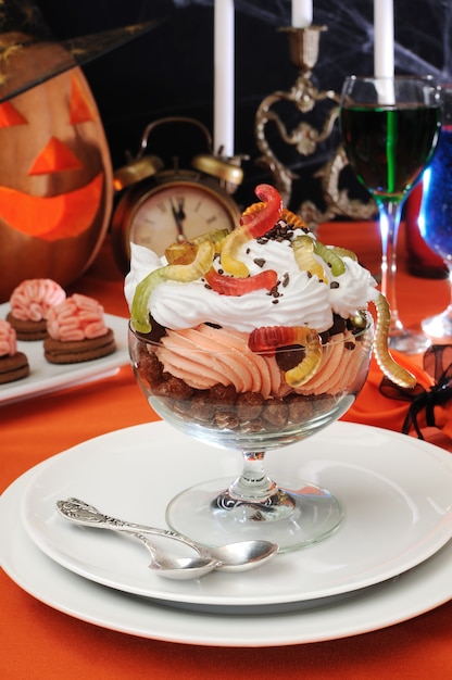 Chocolate balls covered with whipped cream with gelatin worms