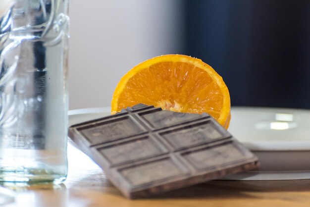 A chocolate bar and a glass of water on a table