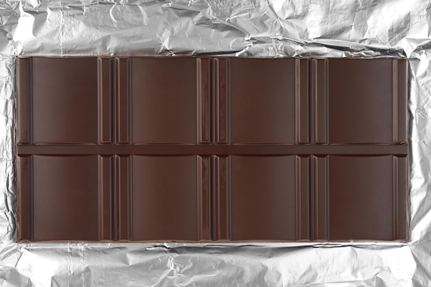 Chocolate bar on shiny silver foil