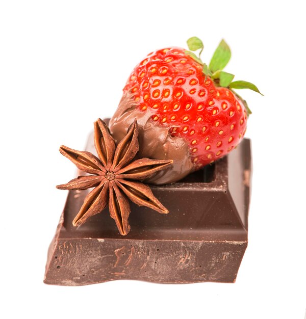 Chocolate bars with its ingredients and strawberry