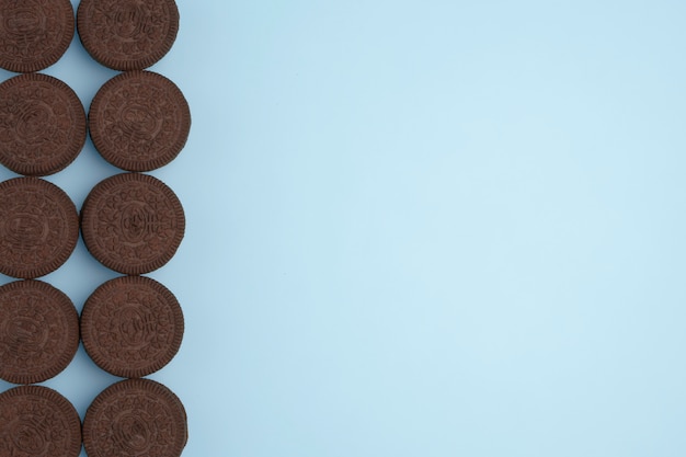 Chocolate biscuits on blue background. Copy space for text. Flat lay.