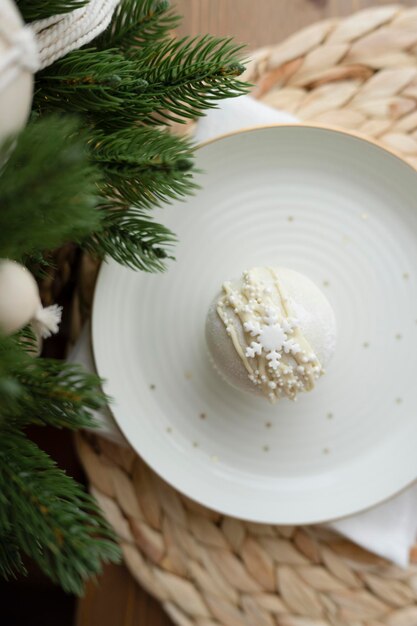 Chocolate bomb for a milk drink on a plate