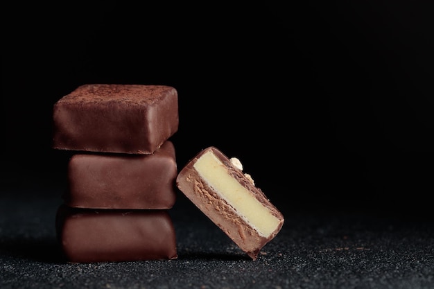 Chocolate bonbons with praline on black background