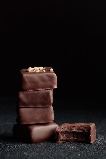 Chocolate bonbons with praline on black background