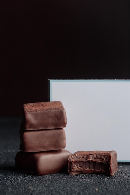 Chocolate bonbons with truffle on black background