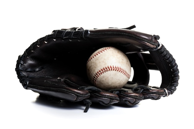 Chocolate brown baseball glove with the old ball isolated over white background