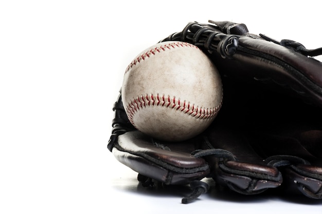 Chocolate brown baseball glove with the old ball isolated over white background