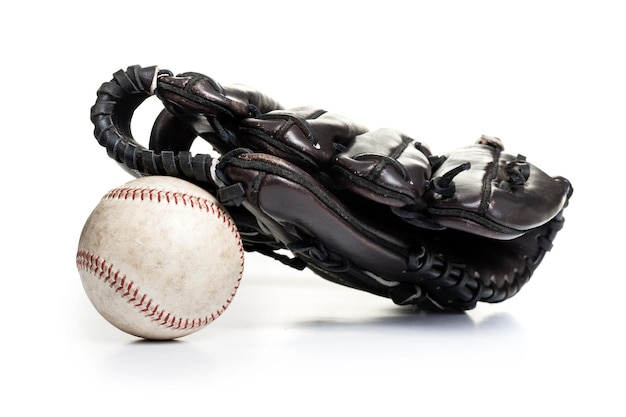 Chocolate brown baseball glove with the old ball isolated over white background