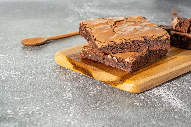 chocolate brownie, homemade tasty and delicious dessert over wooden board, and stone marble