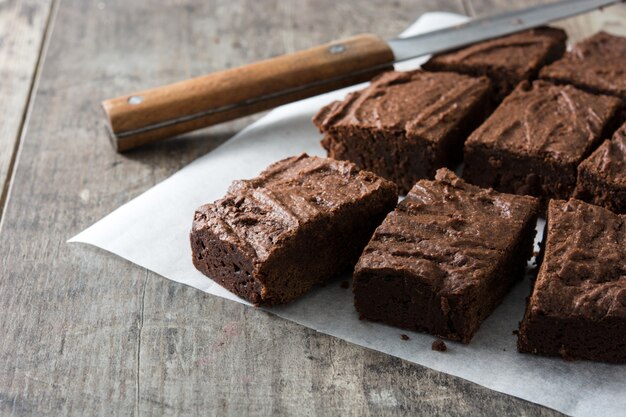 Chocolate brownie portions on wooden