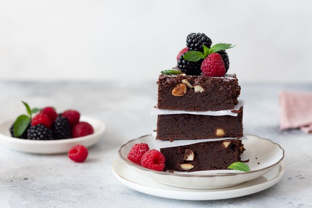 Chocolate brownie square pieces with berries