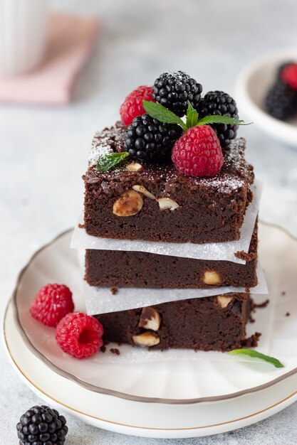 Chocolate brownie square pieces with berries