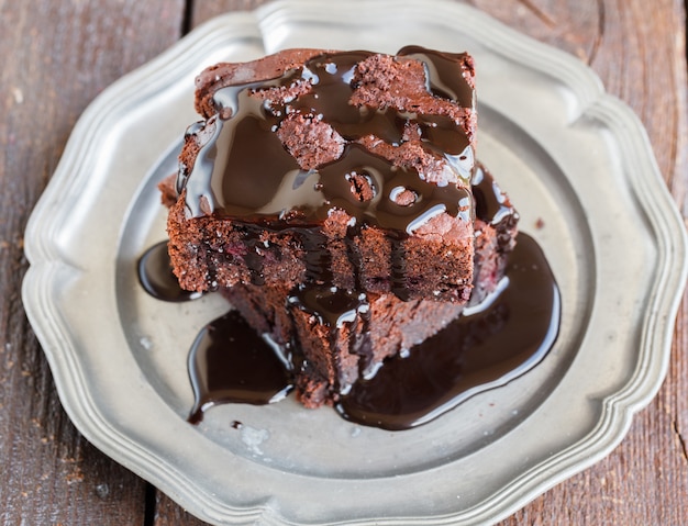 Chocolate brownie with raspberries in chocolate glaze