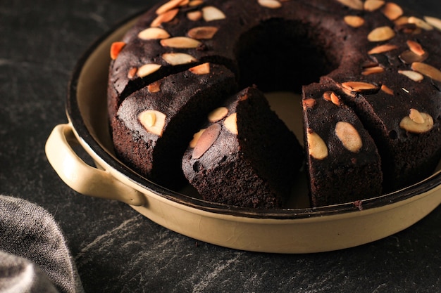 Chocolate Brownies Decorated with Almond Slice on Dark Background