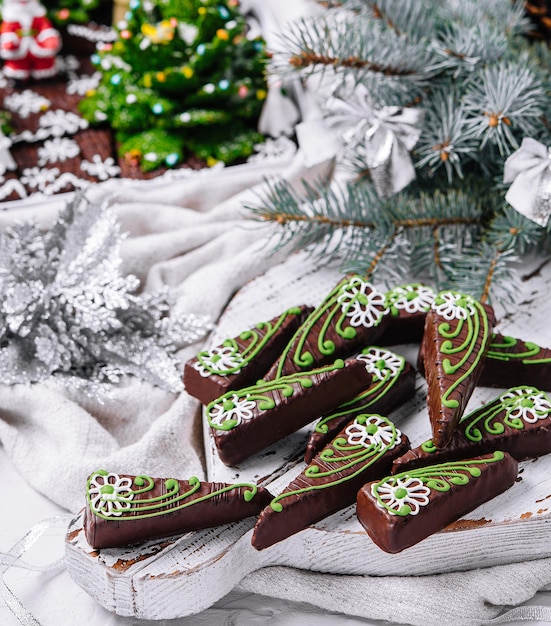 Chocolate brownies in shape of christmas trees with green icing