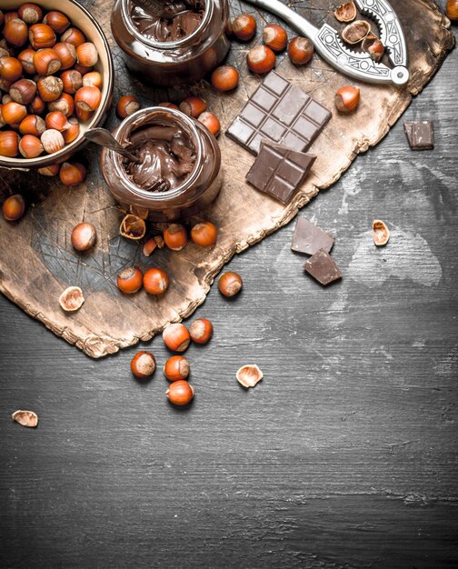 Chocolate butter with hazelnuts on a black chalkboard