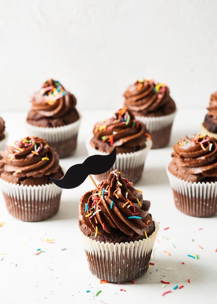 Chocolate cacao cupcakes with moustache and sprinkles decor fathers day