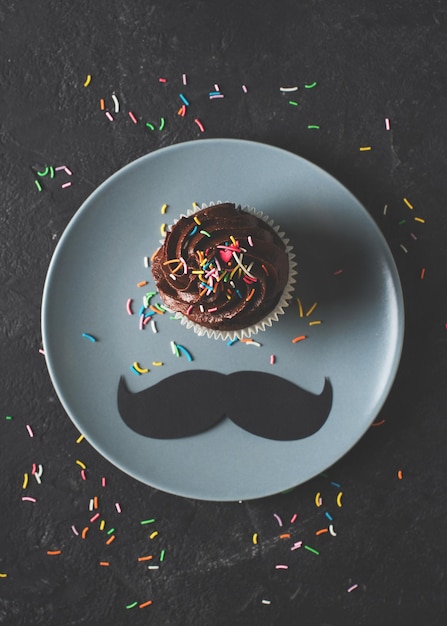 Chocolate cacao cupcakes with sprinkles and mustache fathers day concept