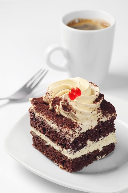 Chocolate cake and cup of coffee on white background