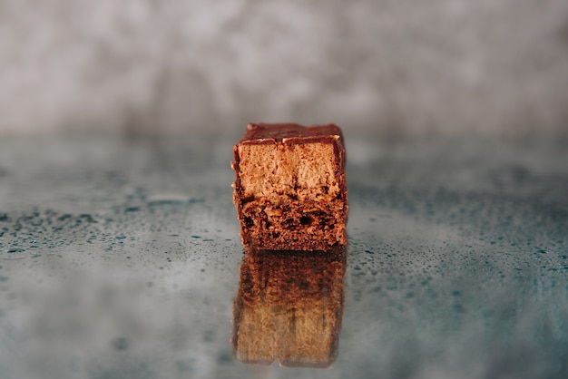 Chocolate cake cut on a mirror surface