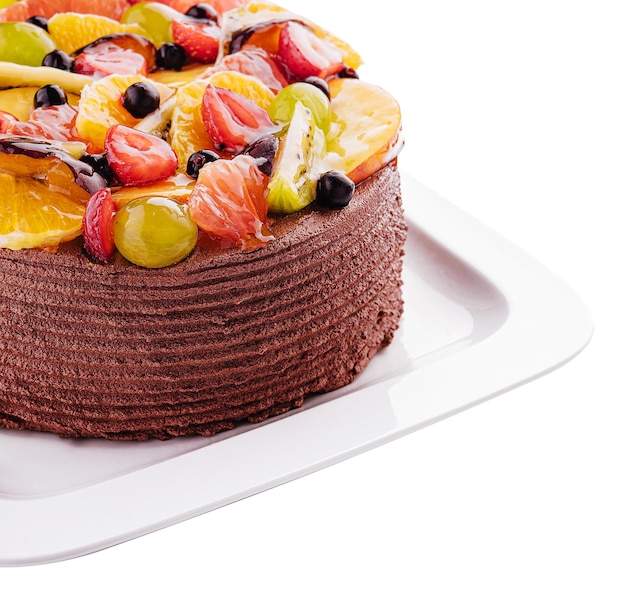 Шоколадный торт с украшенными ягодами и фруктами на тарелке