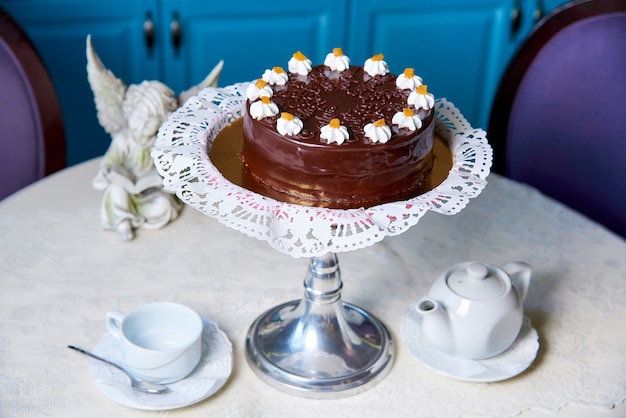 A chocolate cake on a decorated table.