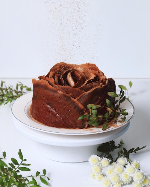 Chocolate cake in the form of a rose on a white background A sweet treat for the holiday