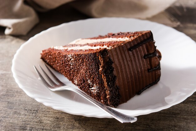 Chocolate cake slice on wooden table