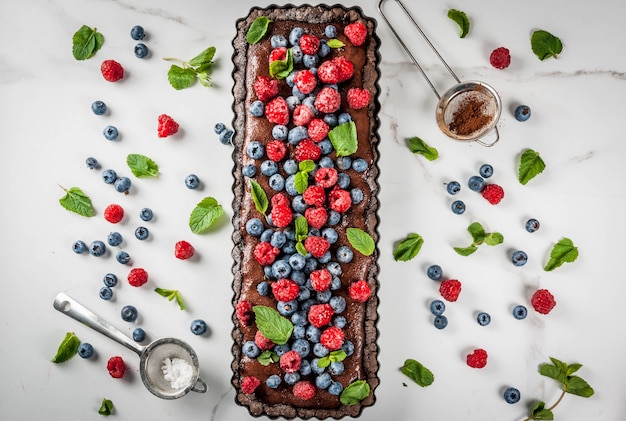 Chocolate cake tart with chocolate cream and fresh summer berries