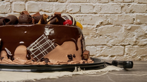 Chocolate cake with cherry and peach chocolates decoration side view