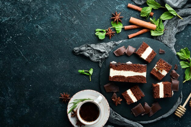 Chocolate cake with creamy mousse filling Dessert On a black background Top view