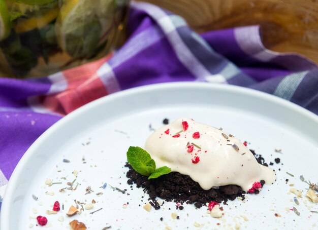 Chocolate cake with ice cream and mint leaves on a white plate