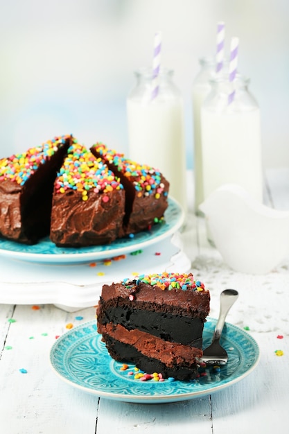 Chocolate cake with milk on table closeup