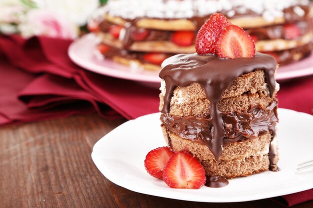 Chocolate cake with strawberry on wooden table closeup