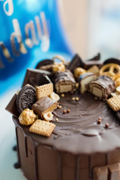 Chocolate cake with sweets and balloon