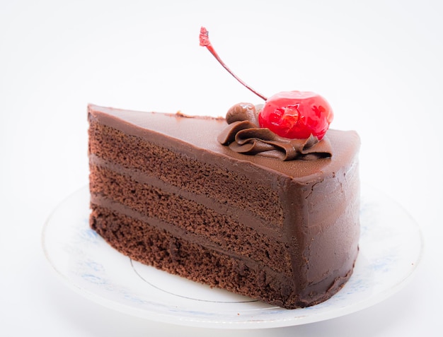 Chocolate cake with topping cherry in ceramic plate Delicious cuisine dessert over white background