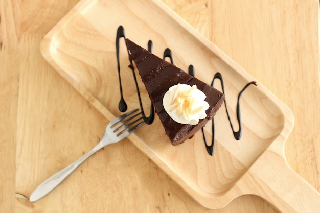 Chocolate cake on wooden plate