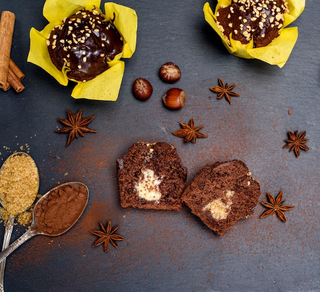 Chocolate cake in yellow paper on a black background