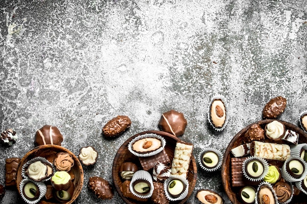 Chocolate candies in a bowls. On a rustic background.