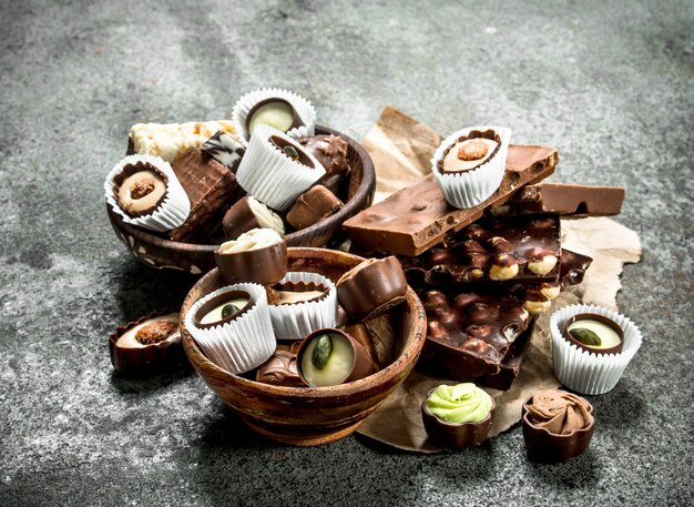 Chocolate candies in a bowls. On a rustic background.