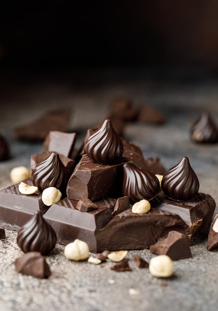 Chocolate candies on brown background The chunks of broken chocolate